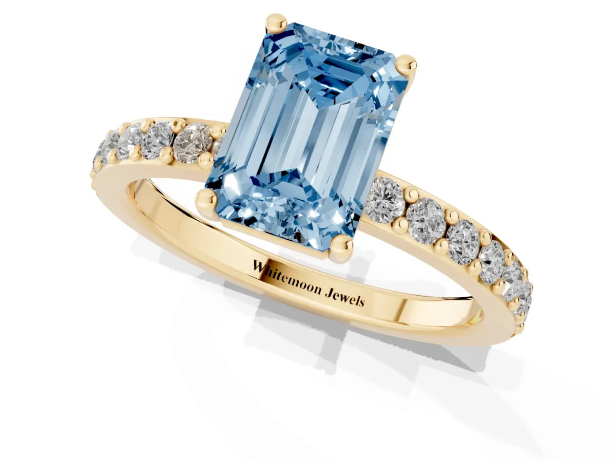 Fancy Blue Emerald Cut Cut Diamond Solitaire with Pave Band and Four-Prong Setting Yellow gold