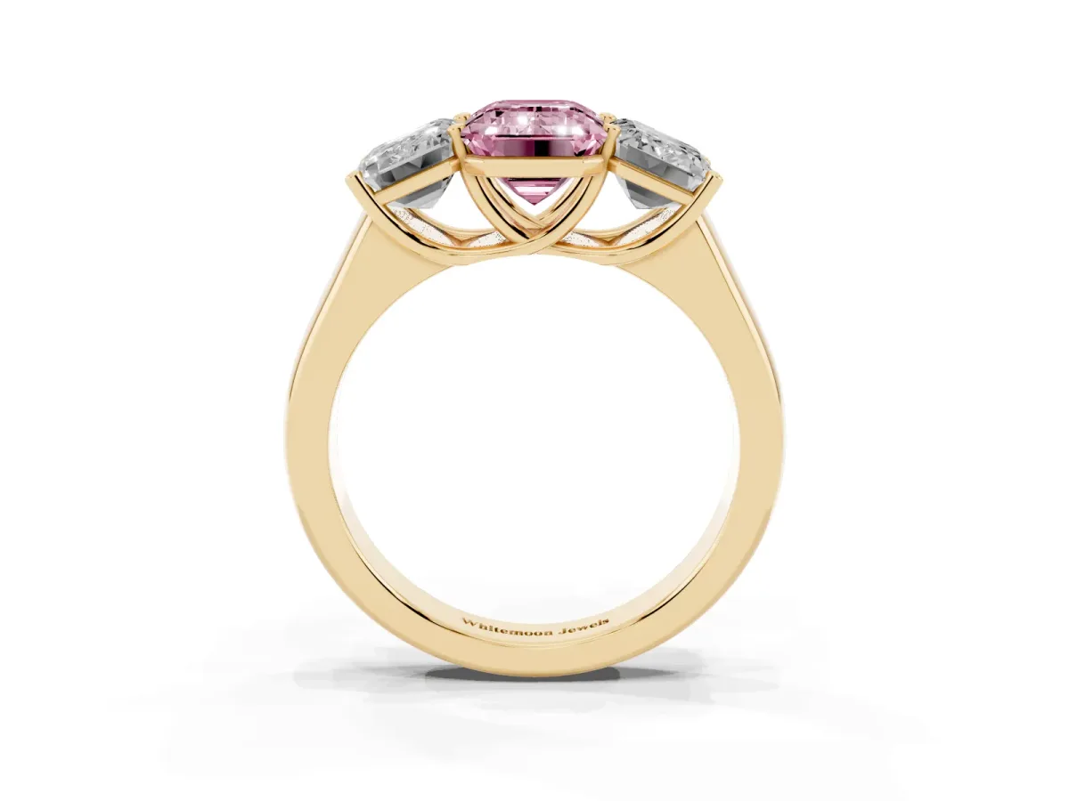 Fancy Pink Emerald Cut Three-Stone Diamond Ring with Prong Setting on a Classic Band Yellow gold