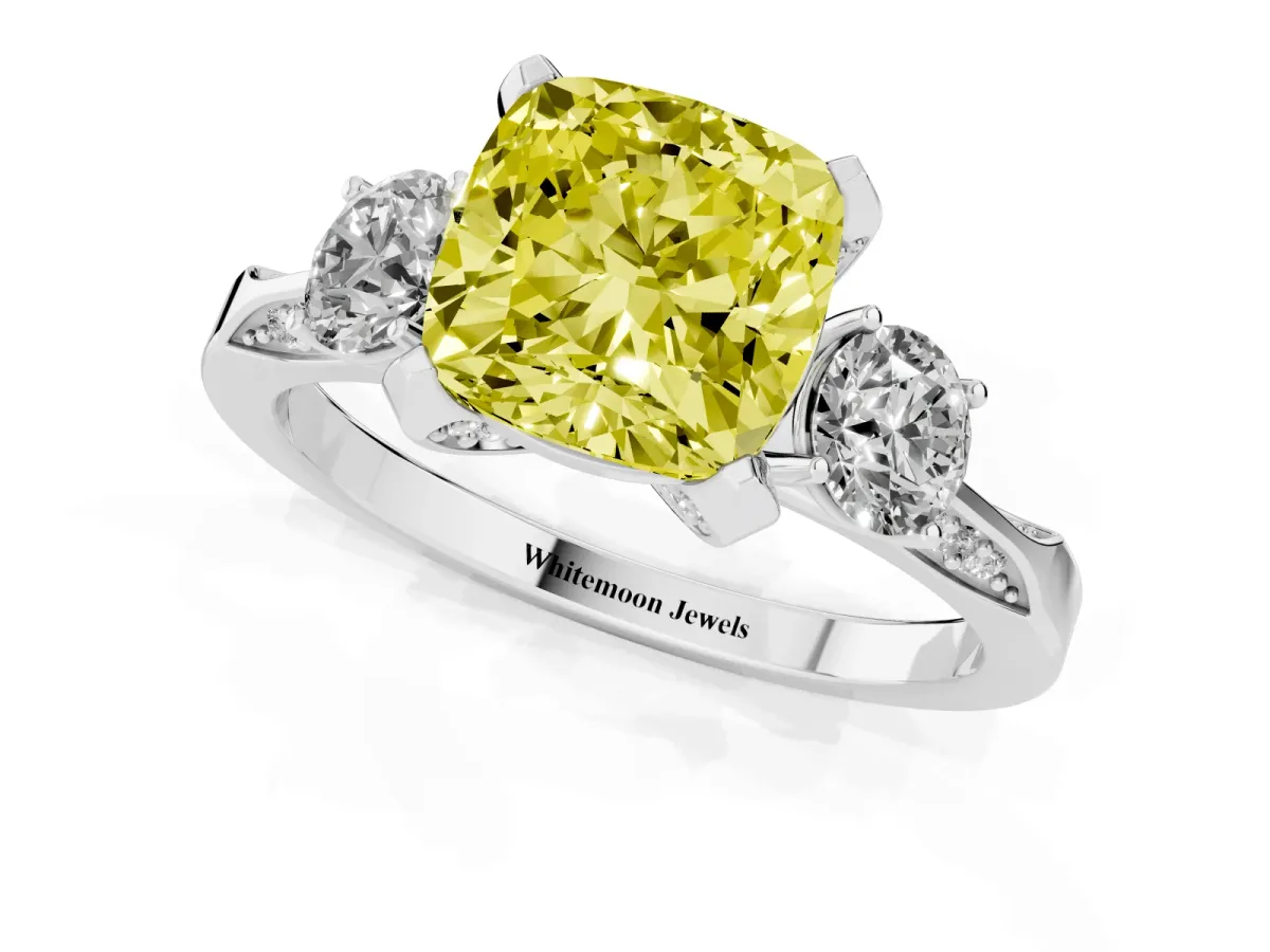 Fancy Yellow Cushion Cut Brilliant Three-Stone Diamond Ring with Pavé Band and Four-Prong Setting Platinum