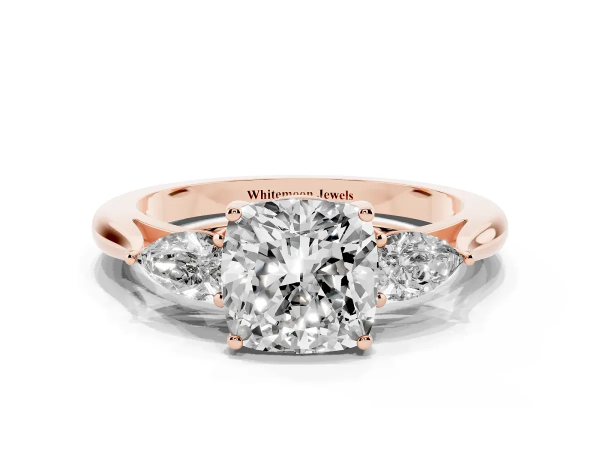 Three-Stone Cushion Cut Diamond Ring with Pear Side Stones in Four-Prong Setting Rose gold