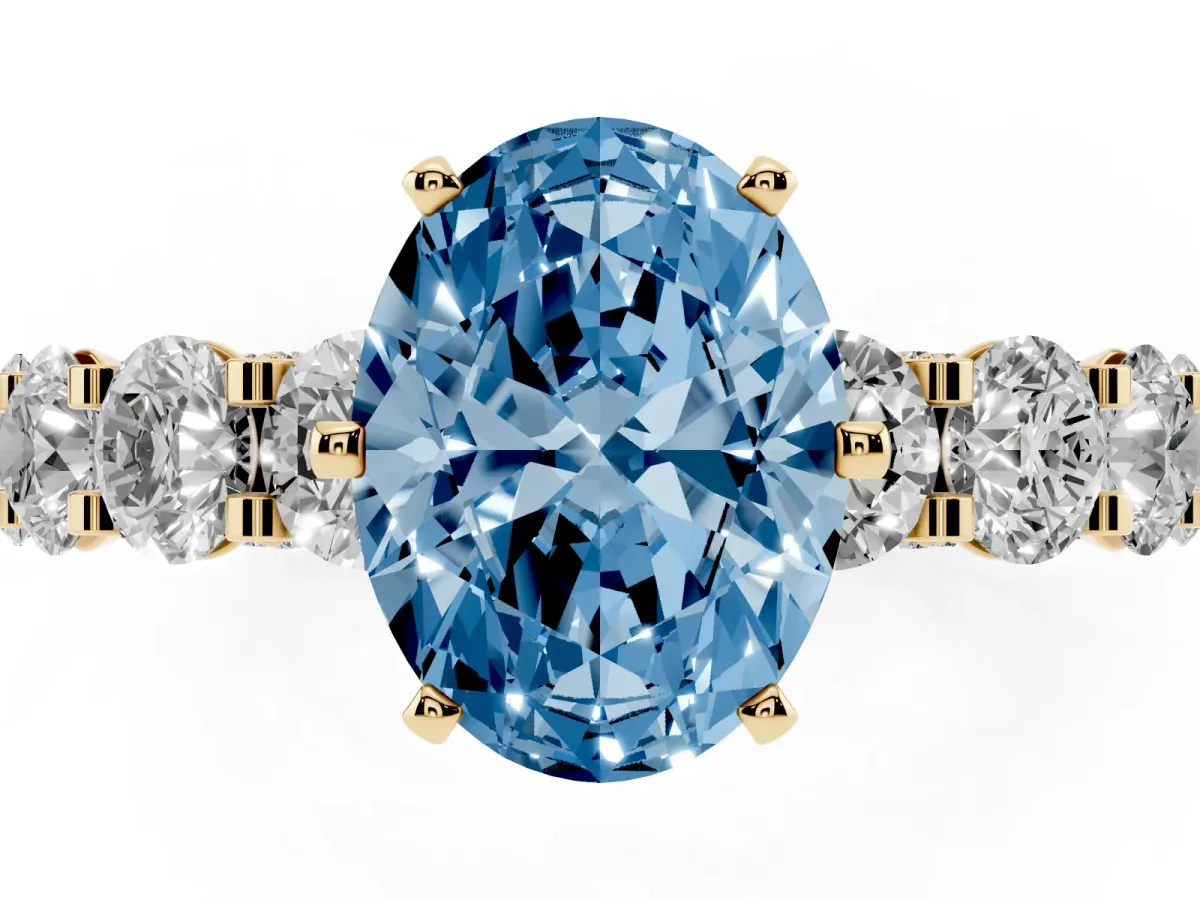Fancy Blue Oval Cut Diamond Side Stone Engagement Ring with Four-Prong Setting Yellow gold