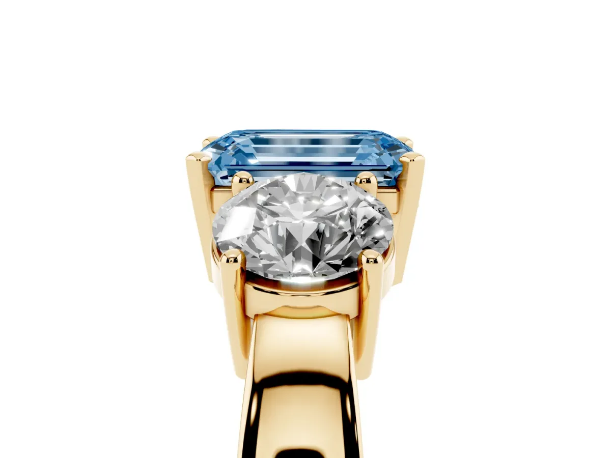 Fancy Blue Three-Stone Emerald Cut Diamond Ring with Round Side Stones, Classic Band, and Four-Prong Setting Yellow gold
