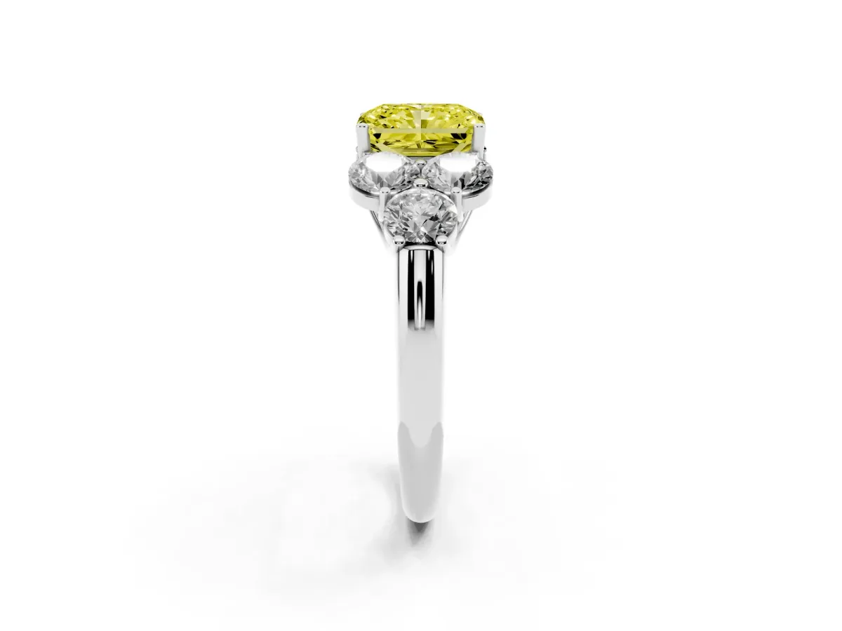 Fancy Yellow Radiant Cut Cut Diamond Cluster Ring with Round Accent Stones and Prong Setting on a Classic Band Platinum