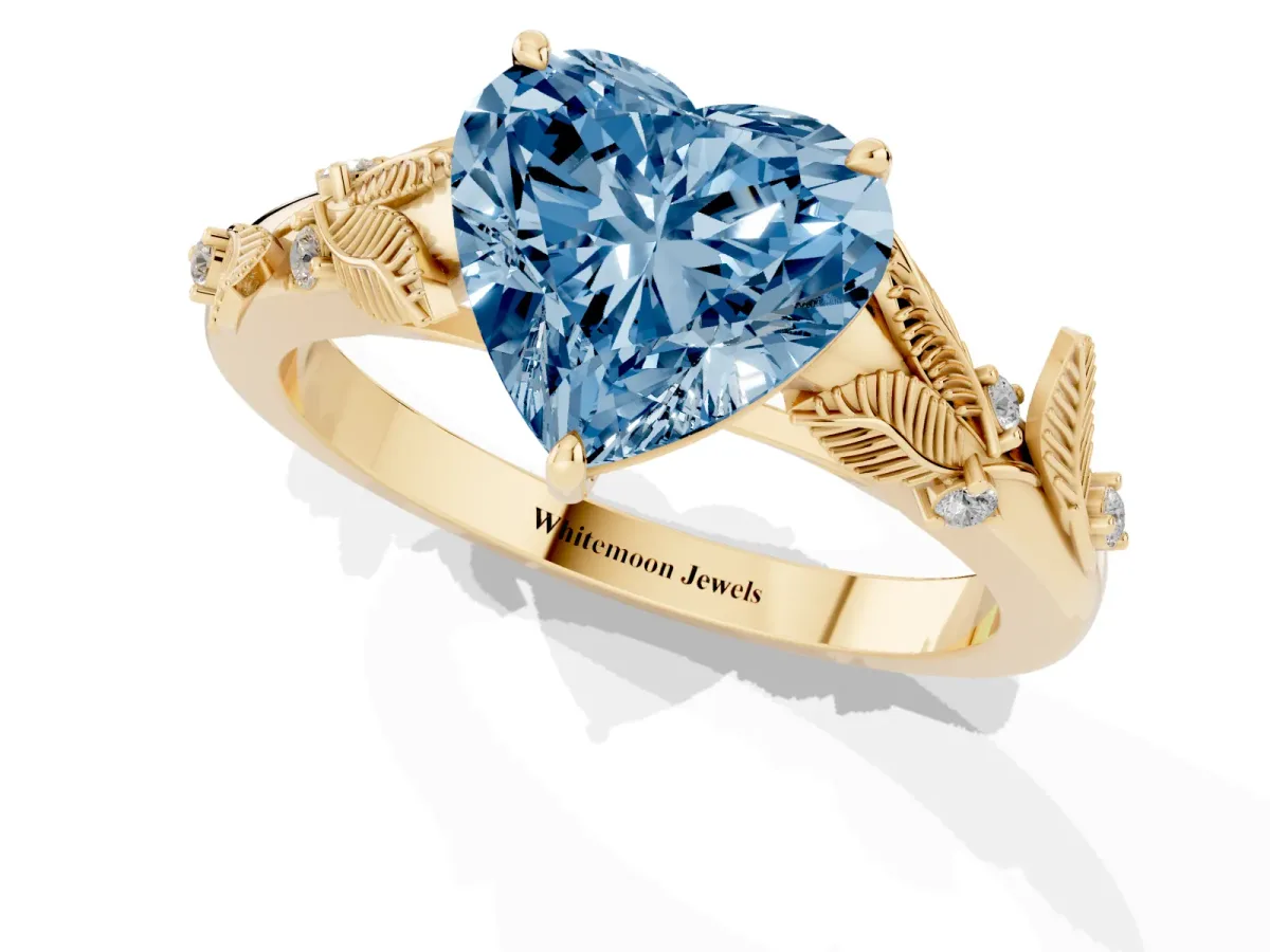 Fancy Blue Heart Cut Diamond Solitaire Ring with Leaf Motif Band and Four-Prong Setting Yellow gold