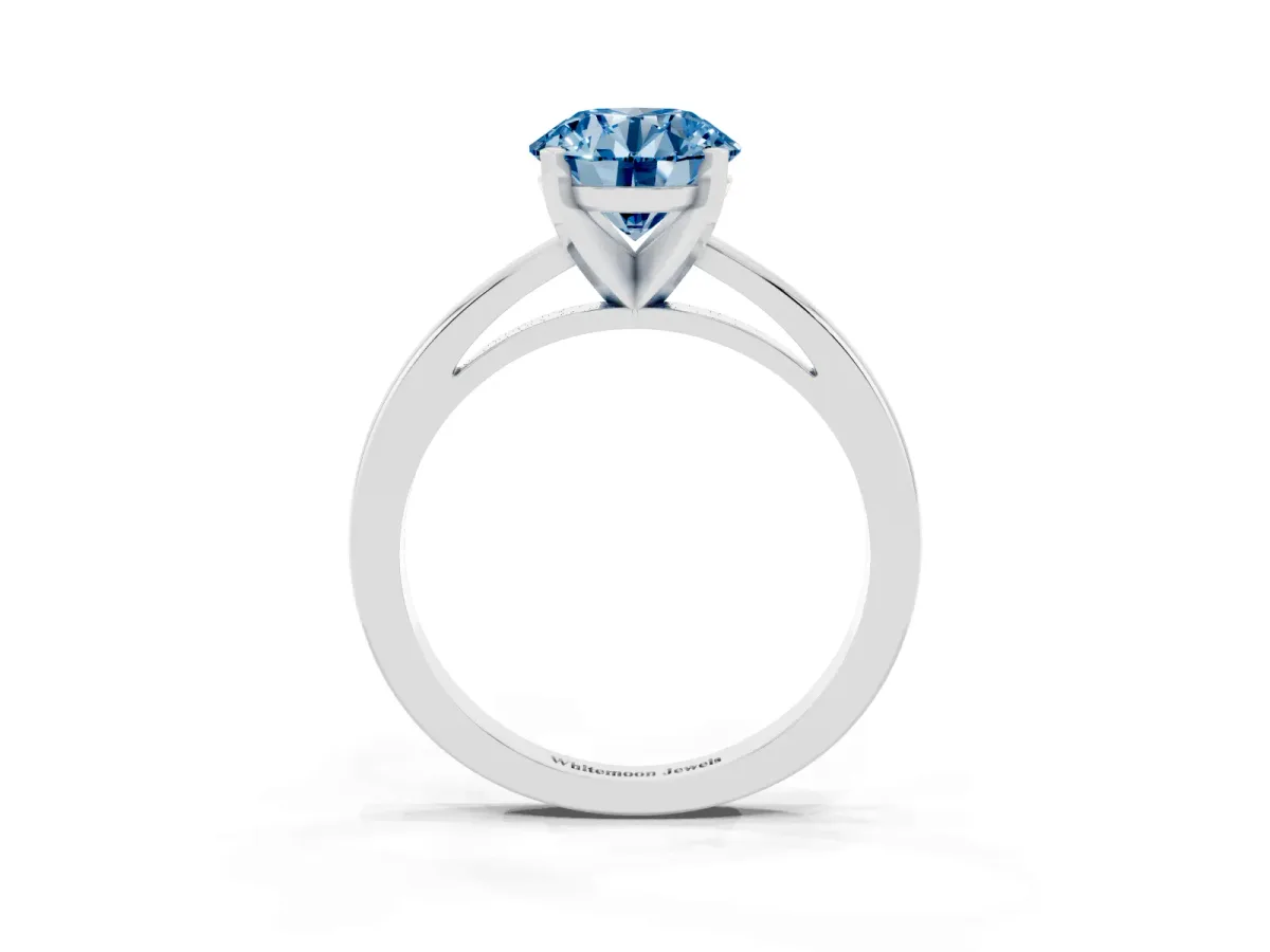 Fancy Blue Round Cut Solitaire Diamond Engagement Ring with Four-Prong Setting on a Classic Band Silver