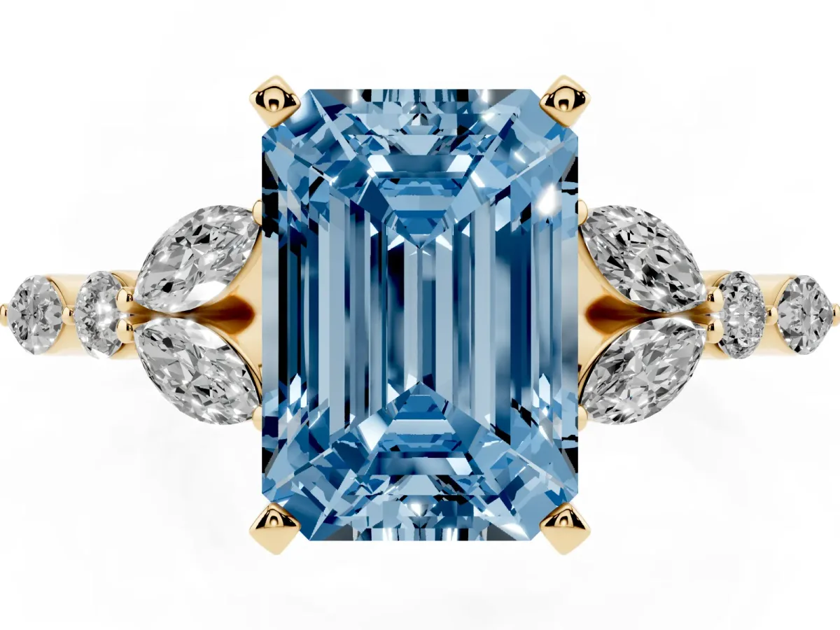 Fancy Blue Emerald Cut Diamond Solitaire Ring with Side Stones and Four-Prong Setting Yellow gold