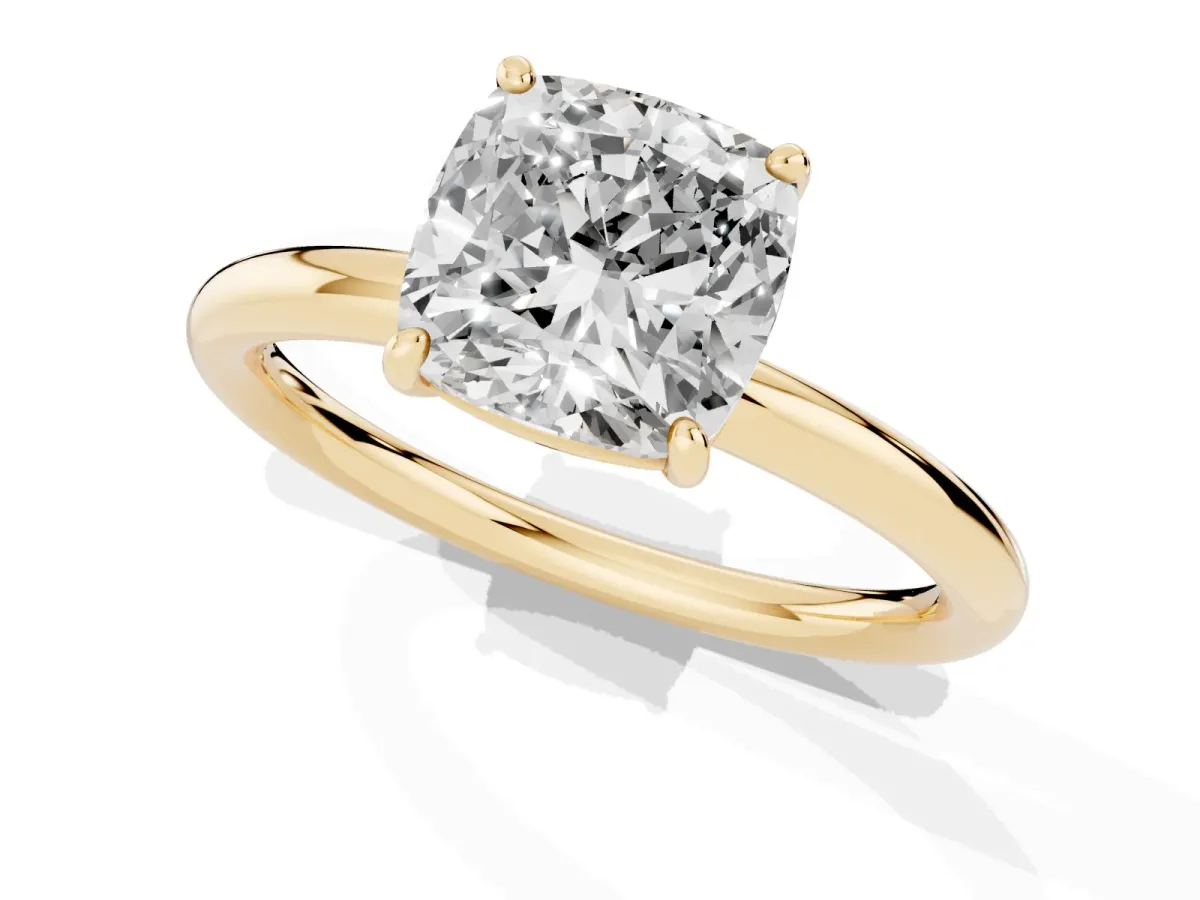 Cushion Cut Solitaire Diamond Ring with Four-Prong Setting on a Plain Band Yellow gold