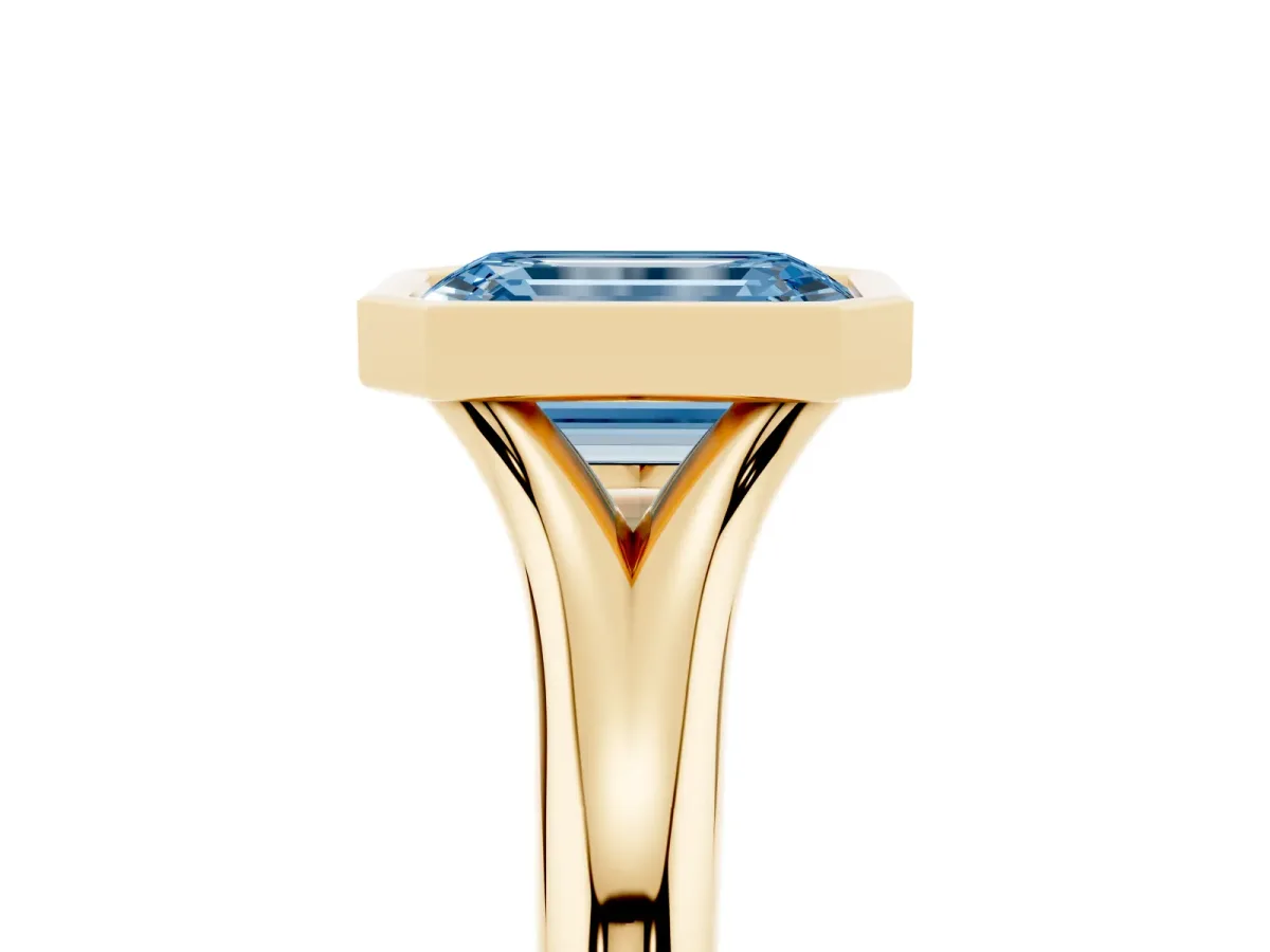 Fancy Blue Bezel Set Emerald Cut Solitaire Diamond Ring with Smooth Band Yellow gold