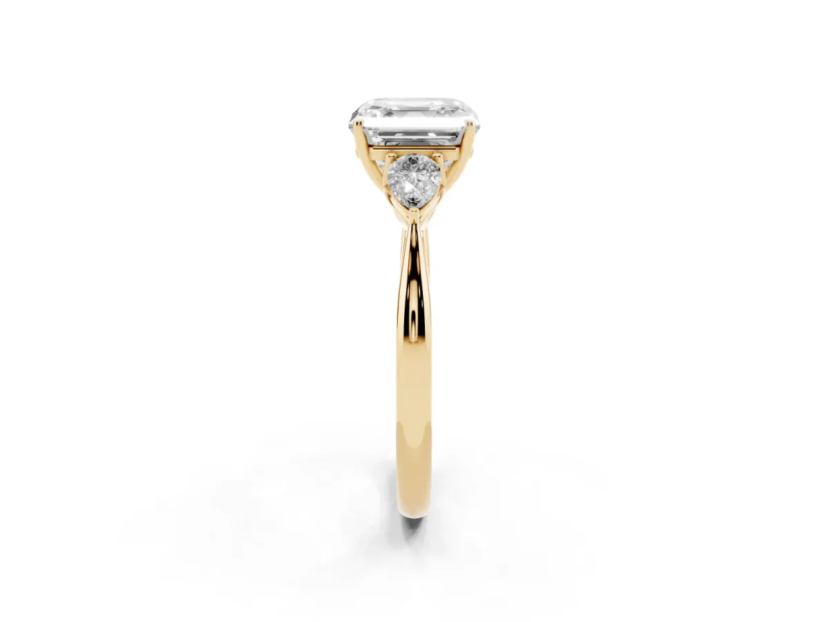 Three-Stone Asscher Cut Diamond Ring with Pear Side Stones in Four-Prong Setting Yellow gold