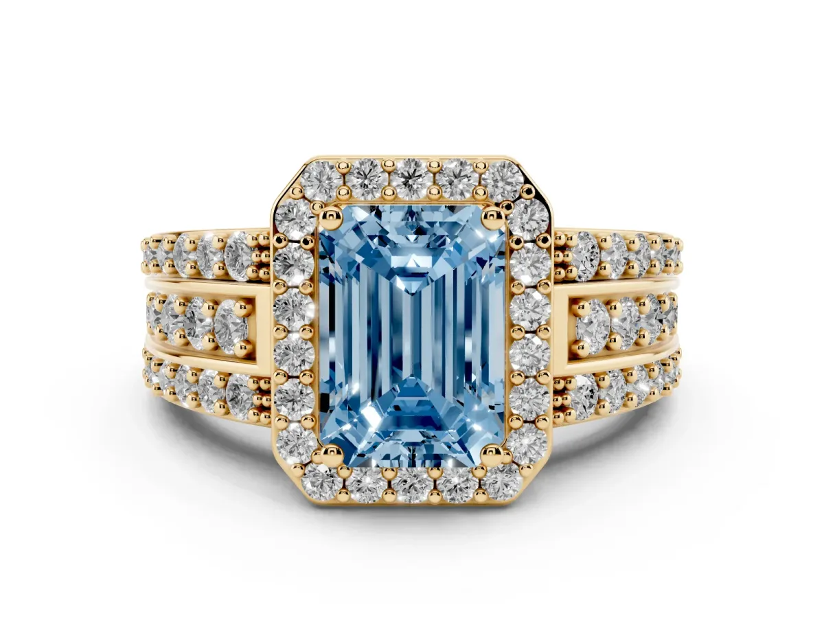 Fancy Blue Emerald Cut Halo Diamond Ring with Round Split Shank and Prong Setting Yellow gold