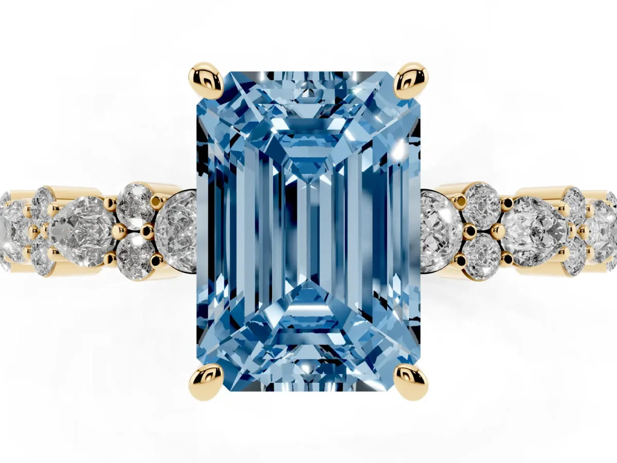 Fancy Blue Emerald Cut Diamond Side Stone Solitaire Ring with Round and Four-Prong Setting Yellow gold