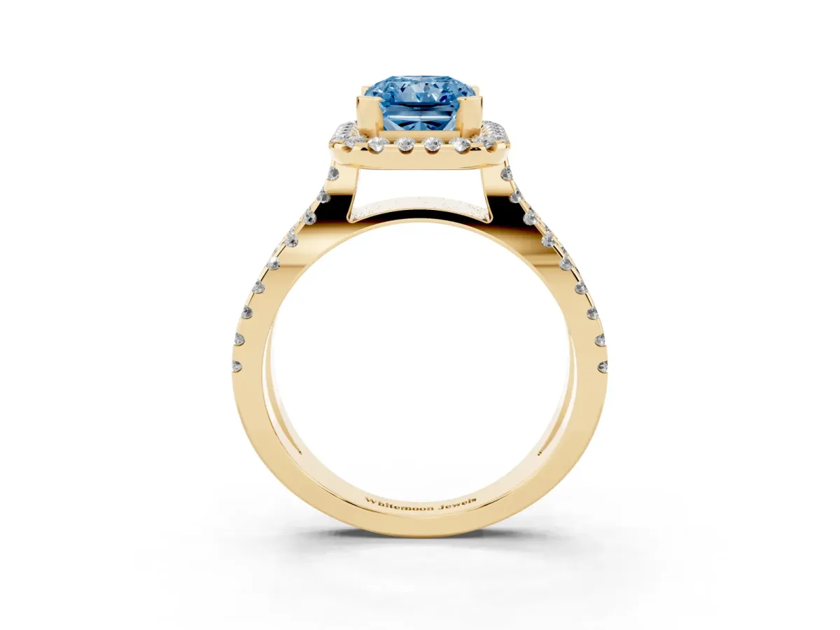 Fancy Blue Radiant Cut Diamond Halo Ring with Split Shank Pavé Band and Prong Setting Yellow gold