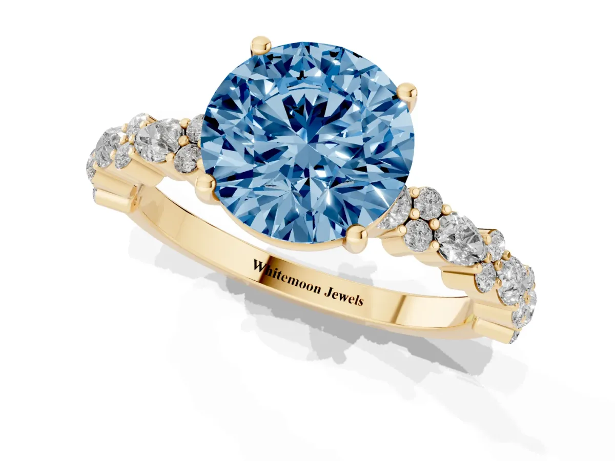 Fancy Blue Round Cut Diamond Side Stone Solitaire Ring with Round and Four-Prong Setting Yellow gold