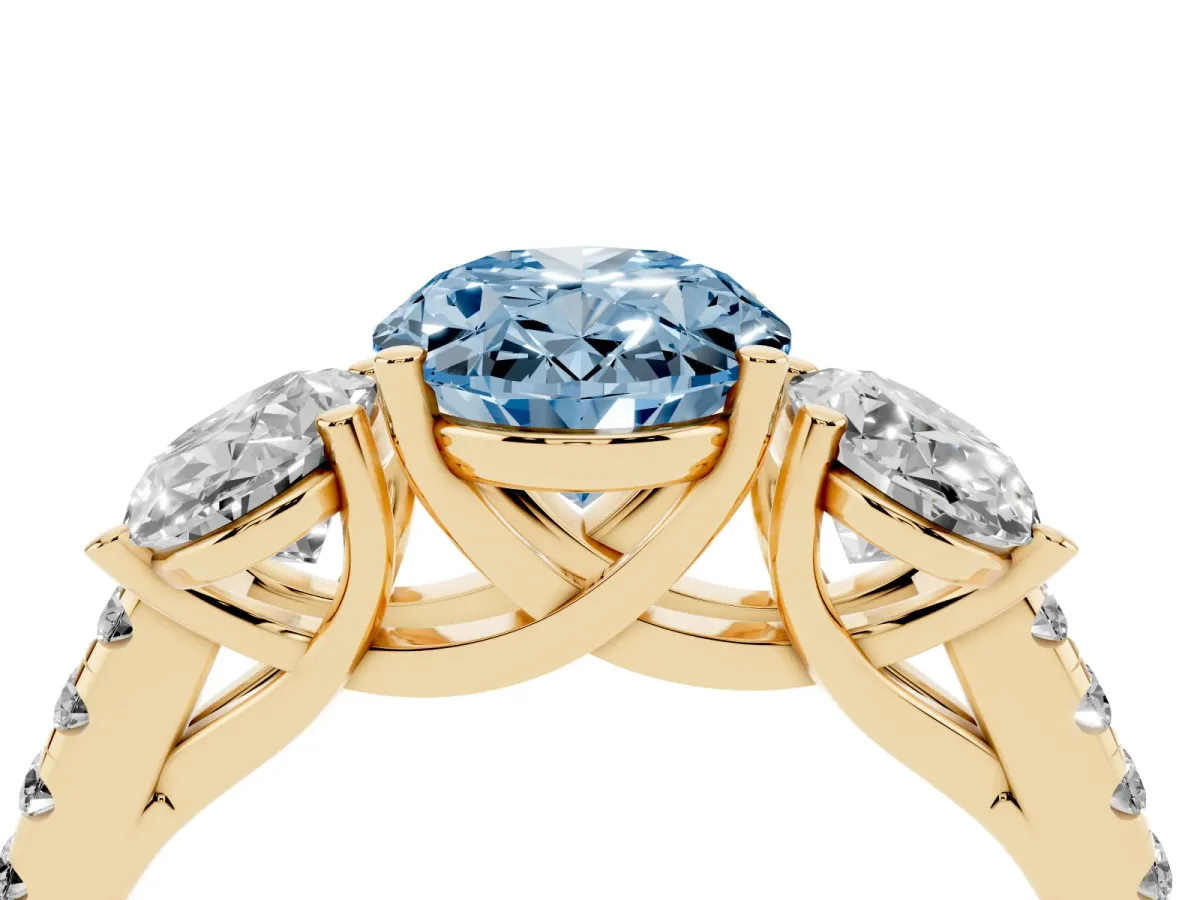 Fancy Blue Three-Stone Oval Cut Diamond Ring with Round Pavé Band and Prong Setting Yellow gold