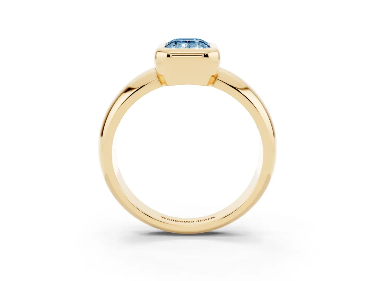 Fancy Blue Bezel Set Emerald Cut Solitaire Ring with Wide Band Yellow gold
