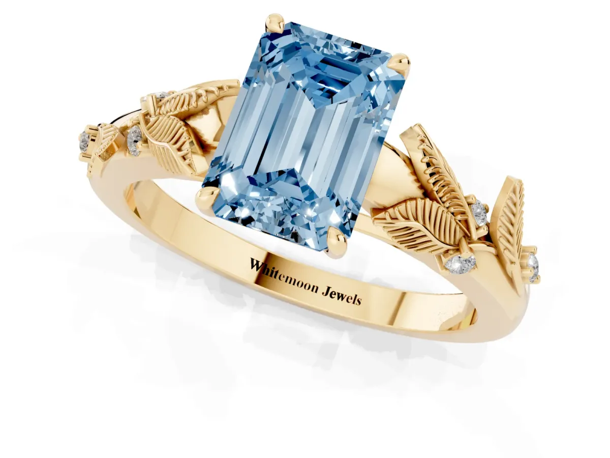 Fancy Blue Emerald Cut Diamond Solitaire Ring with Leaf Motif Band and Four-Prong Setting Yellow gold