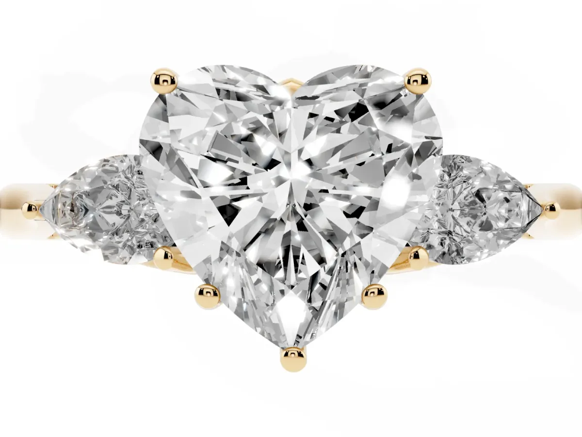 Three-Stone Heart Cut Brilliant Diamond Solitaire Ring with Tapered Band and Four-Prong Setting Yellow gold