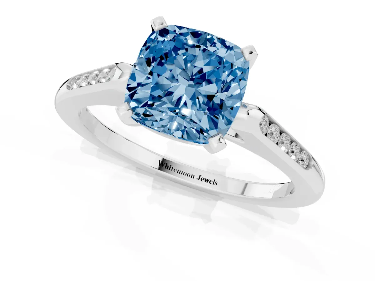 Fancy Blue Cushion Cut Diamond Solitaire Ring with Channel Set Round Band and Prong Setting Silver
