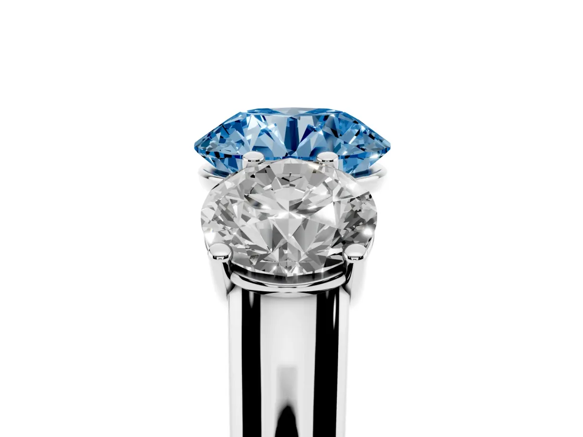 Fancy Blue Round Cut Three-Stone Diamond Ring with Prong Setting on a Classic Band Silver