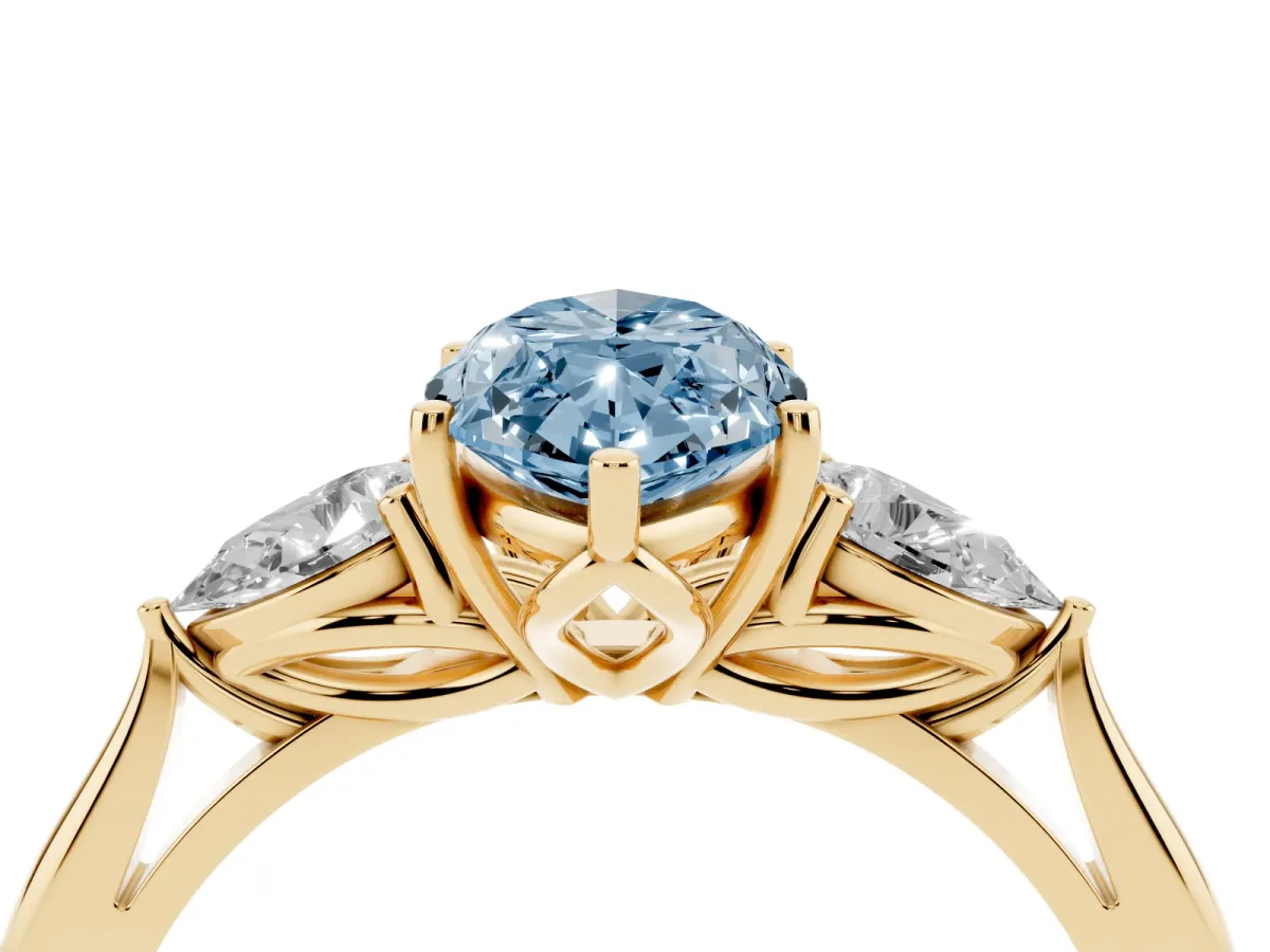 Fancy Blue Three-Stone Marquise Cut Diamond Ring with Pear Side Stones in Four-Prong Setting Yellow gold