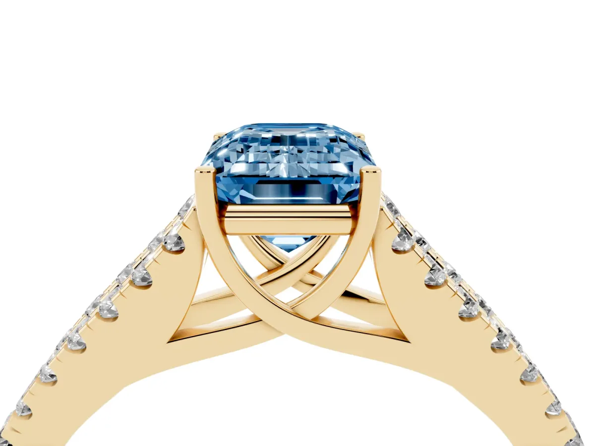 Fancy Blue Emerald Cut Diamond Split Shank Pavé Engagement Ring with Four-Prong Setting Yellow gold