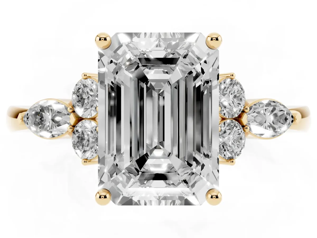 Emerald Cut Brilliant Diamond Solitaire Ring with Pear Side Stones and Four-Prong Setting Yellow gold