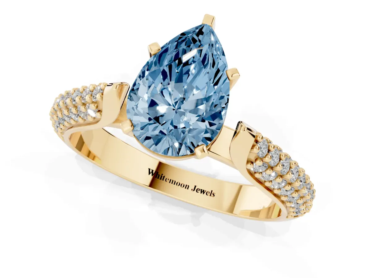 Fancy Blue Pear Cut Diamond Solitaire Engagement Ring with Multi-Row Round Pavé Band and Prong Setting Yellow gold