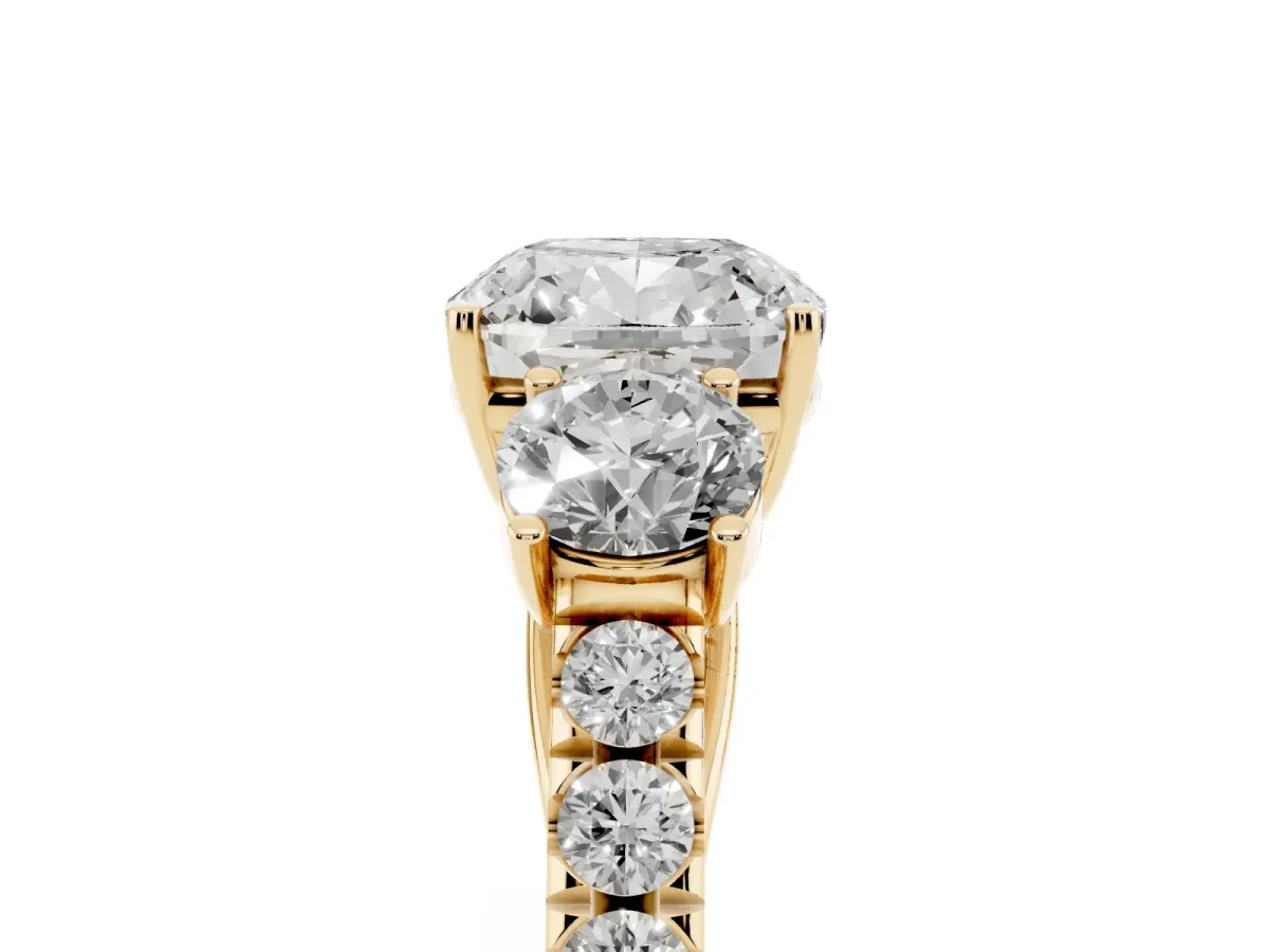 Cushion Cut Cut Diamond Three-Stone Ring with Round Side Stones and Pavé Band Yellow gold