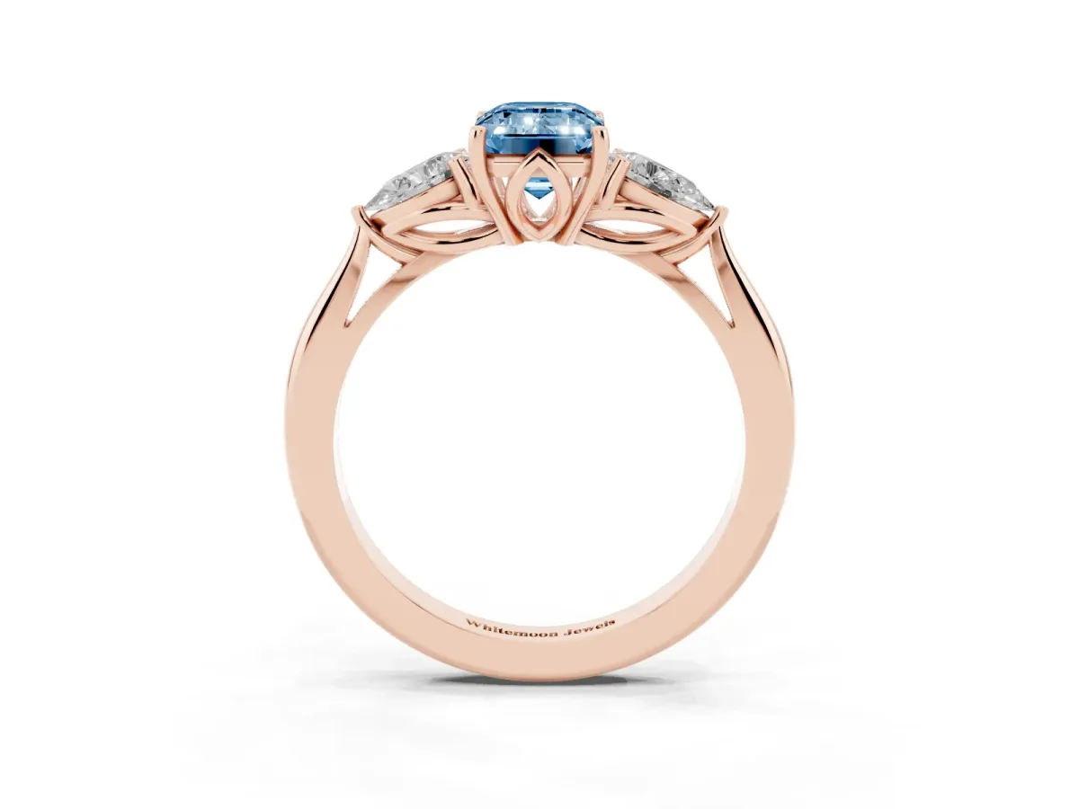 Fancy Blue Three-Stone Emerald Cut Diamond Ring with Pear Side Stones in Four-Prong Setting Rose gold