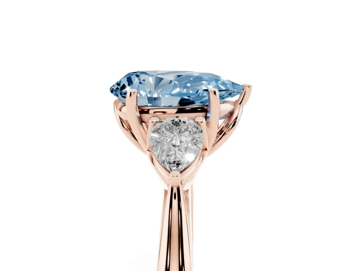Fancy Blue Three-Stone Pear Cut Brilliant Diamond Solitaire Ring with Tapered Band and Four-Prong Setting Rose gold