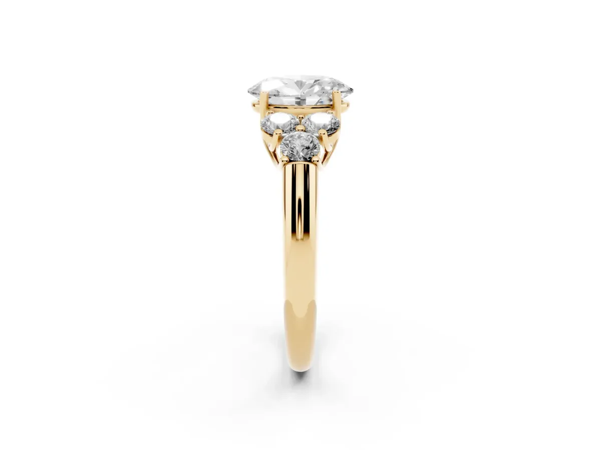 Oval Cut Cut Diamond Cluster Ring with Round Accent Stones and Prong Setting on a Classic Band Yellow gold