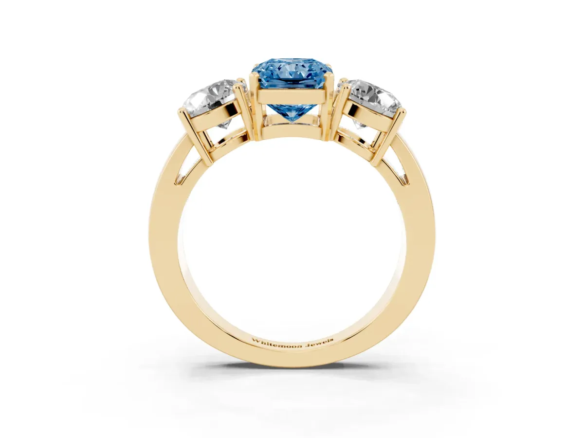 Fancy Blue Three-Stone Radiant Cut Diamond Ring with Round Side Stones, Classic Band, and Four-Prong Setting Yellow gold