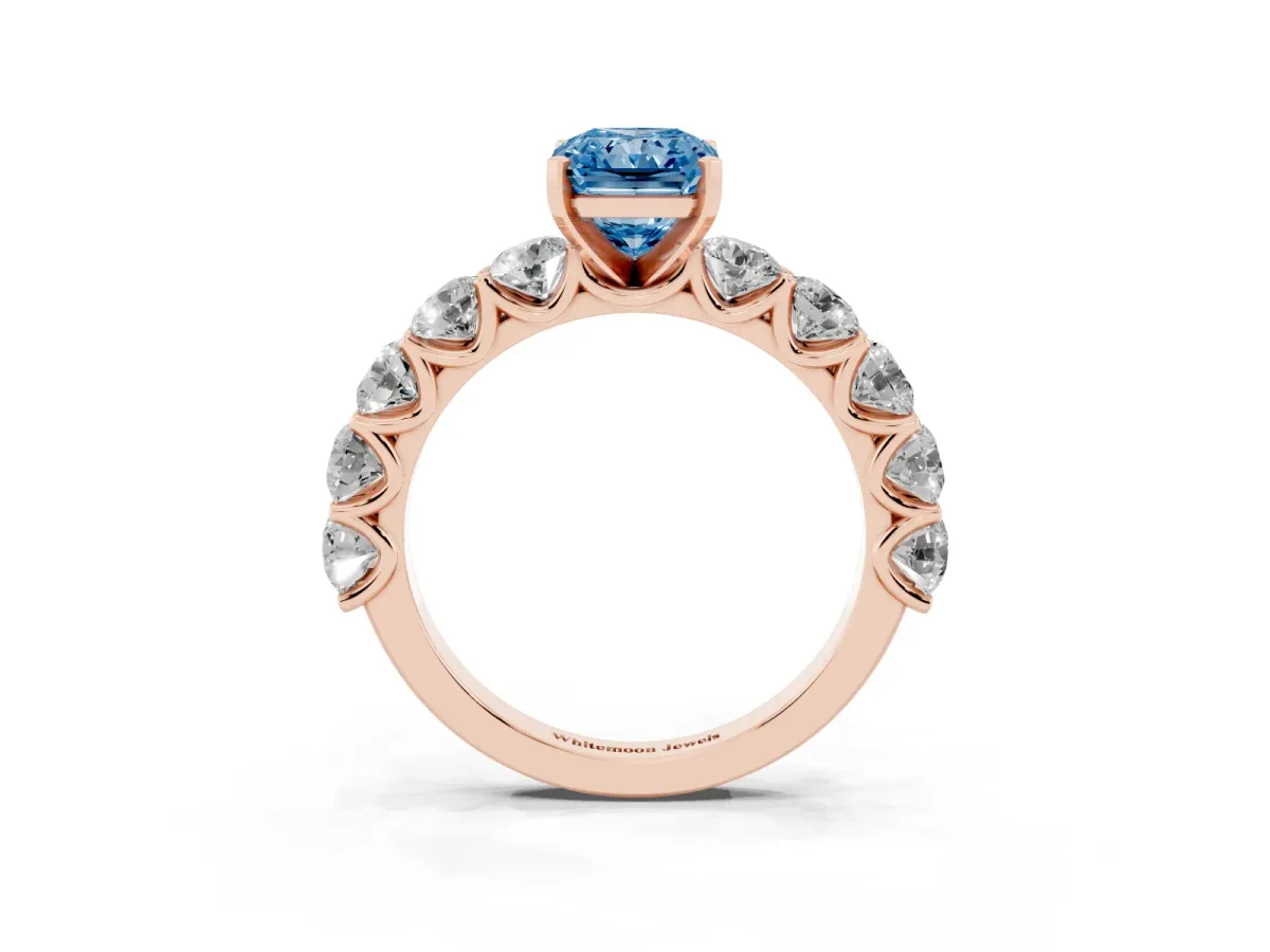 Fancy Blue Radiant Cut Diamond Prong Setting with Side Stones on a Pave Band Rose gold