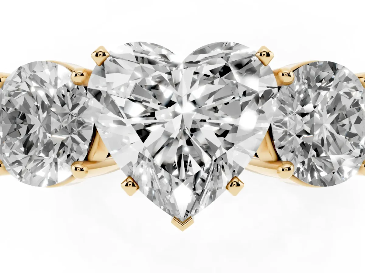 Three-Stone Heart Cut Diamond Ring with Round Side Stones, Classic Band, and Four-Prong Setting Yellow gold