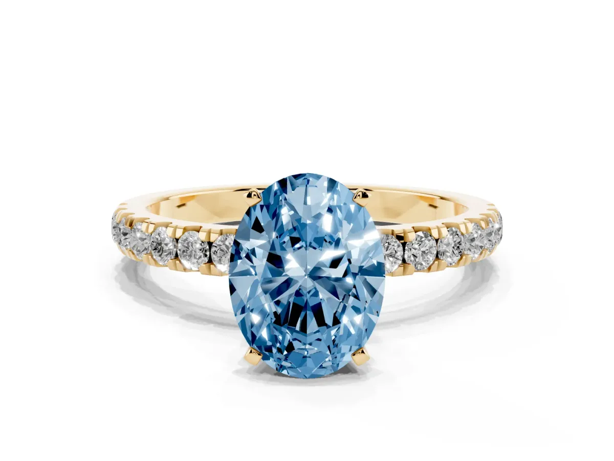Fancy Blue Oval Cut Diamond Solitaire Ring with Pavé Accents and Four-Prong Setting Yellow gold