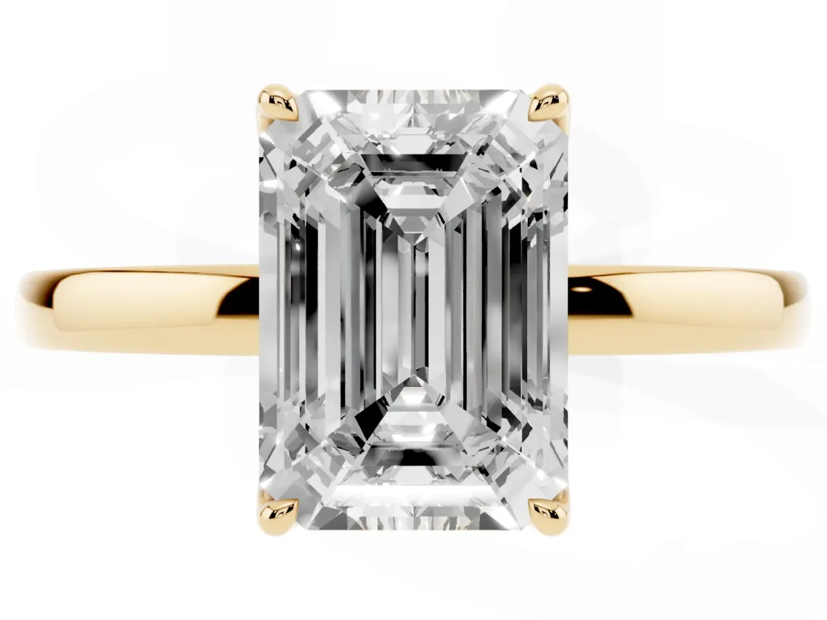 Emerald Cut Diamond Solitaire Ring with Thin Band and Prong Setting Yellow gold