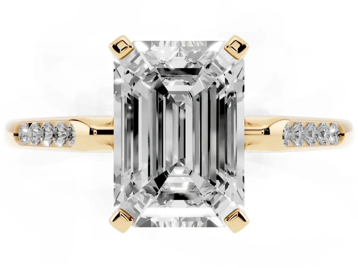 Emerald Cut Diamond Solitaire Ring with Channel Set Round Band and Prong Setting Yellow gold