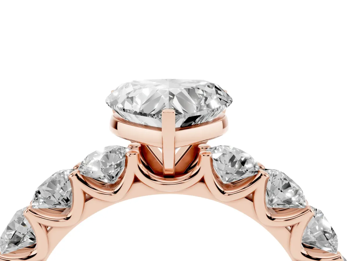 Heart Cut Diamond Prong Setting with Side Stones on a Pave Band Rose gold