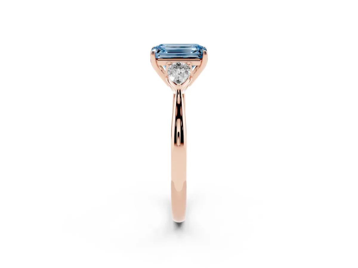 Fancy Blue Three-Stone Emerald Cut Brilliant Diamond Solitaire Ring with Tapered Band and Four-Prong Setting Rose gold