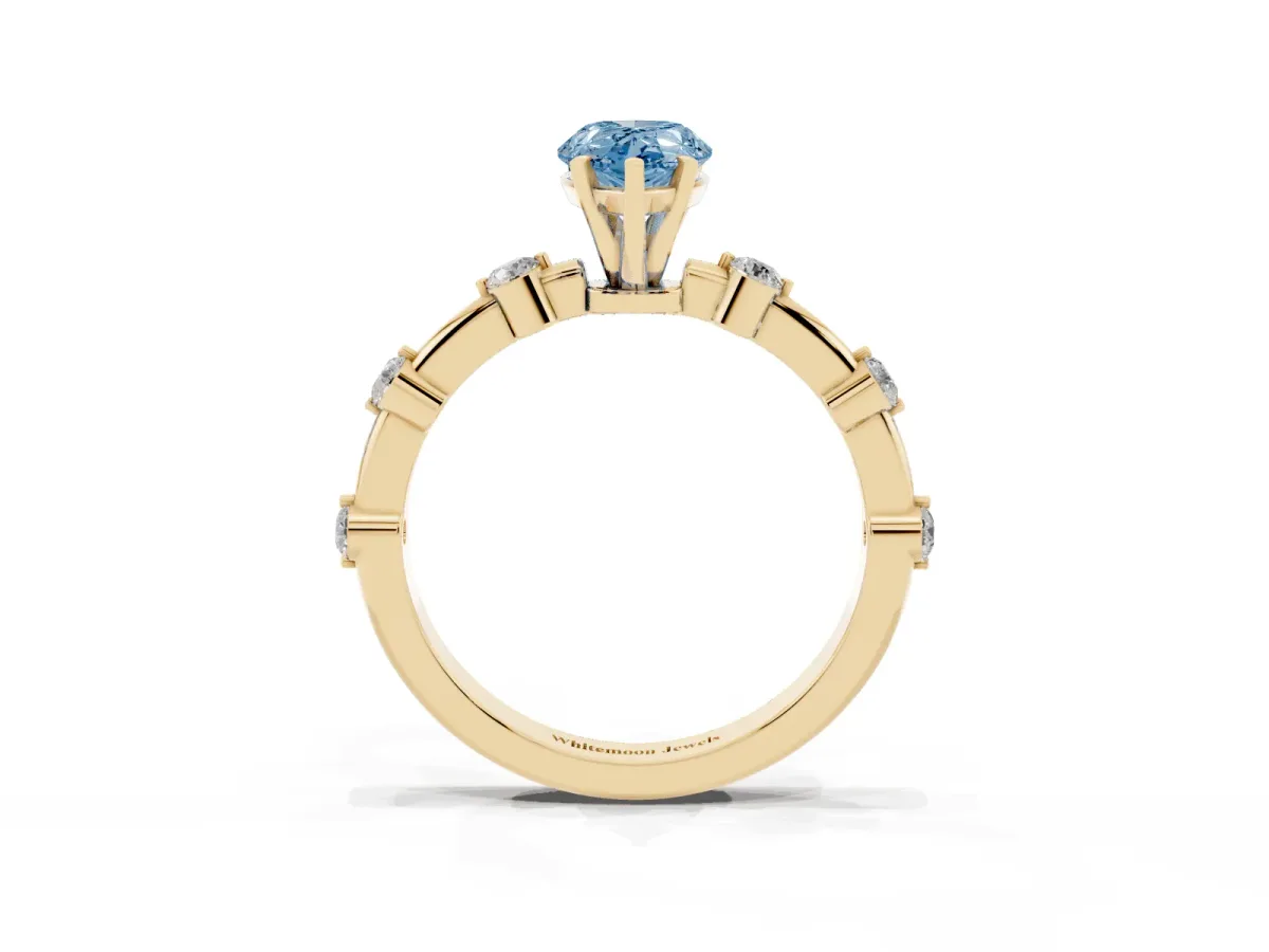 Fancy Blue Pear Cut Solitaire Diamond Ring with Bezel Set Side Stones and Prong Setting Yellow gold