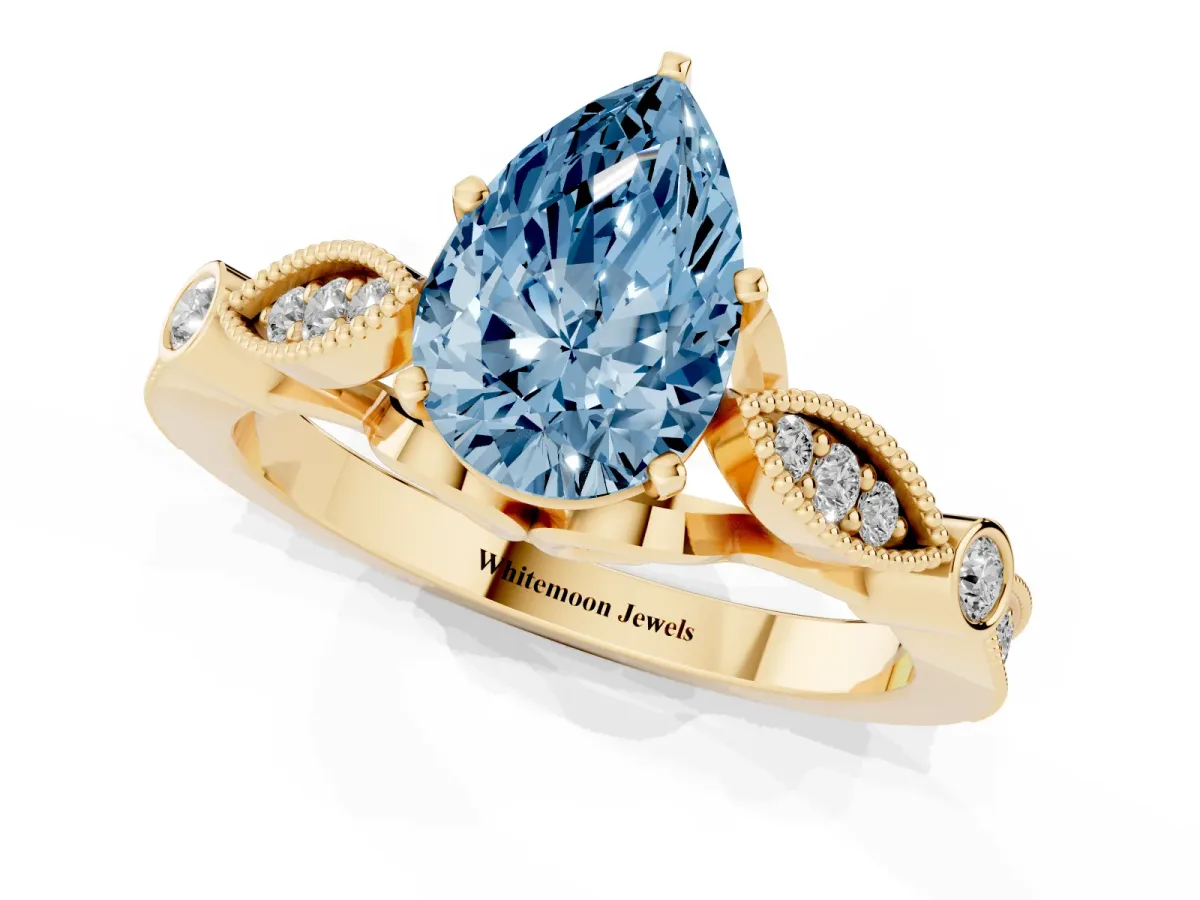 Fancy Blue Pear Cut Cut Diamond with Milgrain Marquise and Bezel Accents on a Solitaire Band with Prong Setting Yellow gold