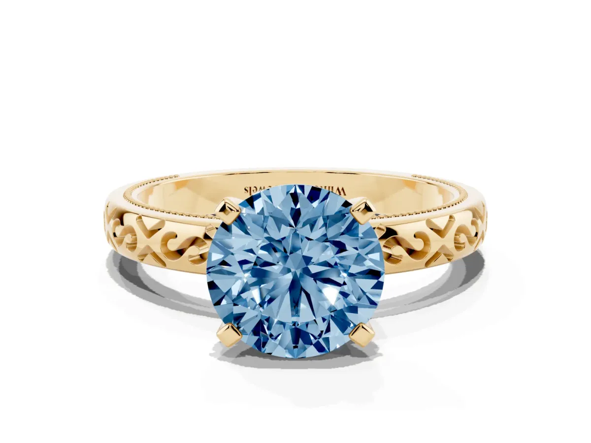 Fancy Blue Round Cut Solitaire Engagement Ring with Scrollwork Band and Four-Prong Setting Yellow gold