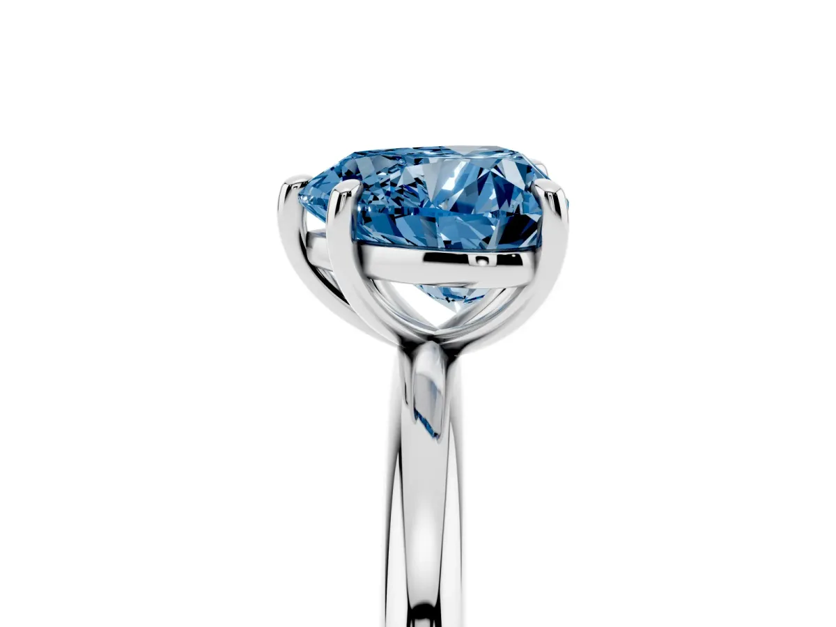 Fancy Blue Heart Cut Solitaire Diamond Ring with Four-Prong Setting on a Plain Band Platinum