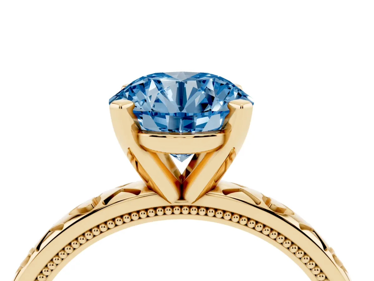 Fancy Blue Round Cut Solitaire Diamond Engagement Ring with XO Engraved Band and Four-Prong Setting Yellow gold