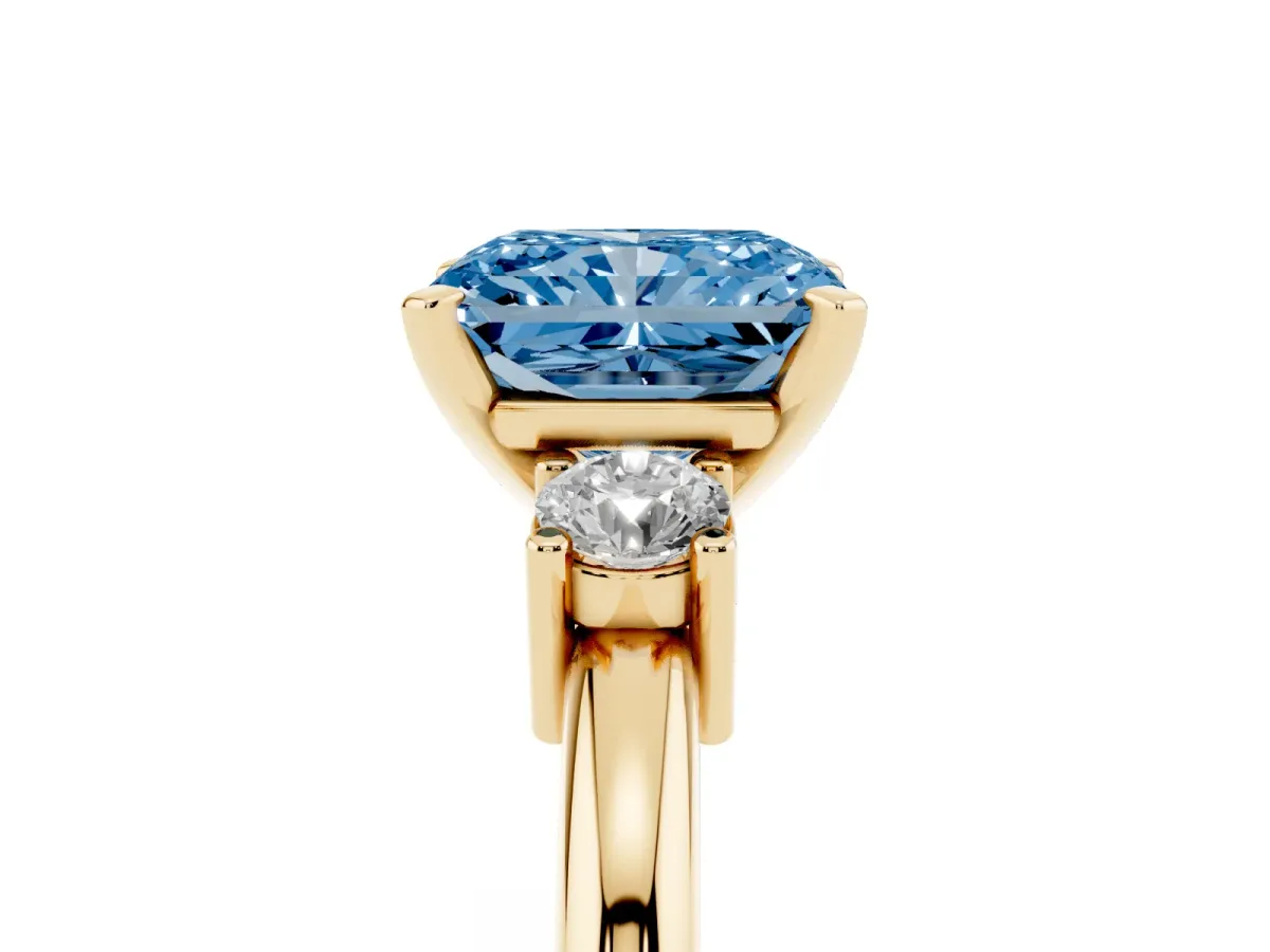 Fancy Blue Three-Stone Radiant Cut Cut Diamond Solitaire with Prong Setting and Classic Band Yellow gold