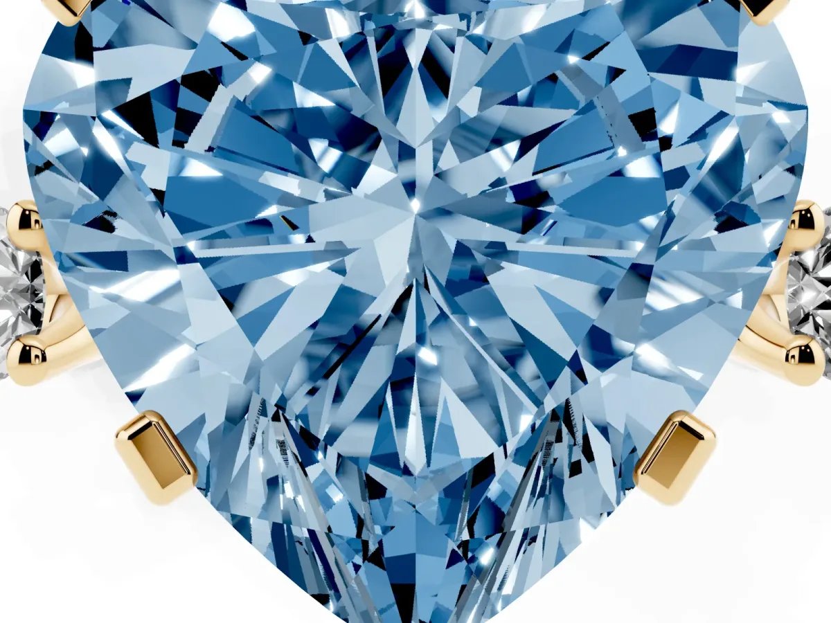 Fancy Blue Heart Cut Cut Three-Stone Solitaire Ring with Round Accent Diamonds and Four-Prong Setting Yellow gold