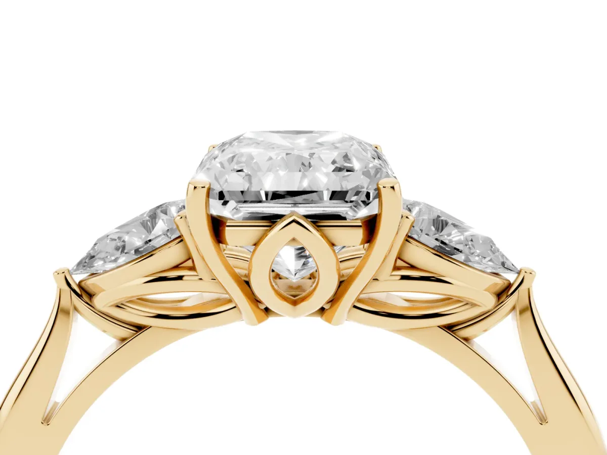 Three-Stone Radiant Cut Diamond Ring with Pear Side Stones in Four-Prong Setting Yellow gold