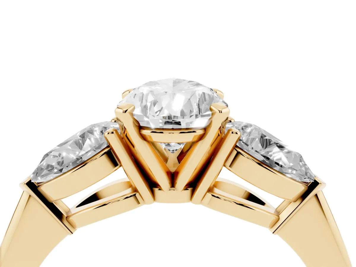 Three-Stone Pear Cut Diamond Ring with Pear Side Stones and Four-Prong Setting Yellow gold