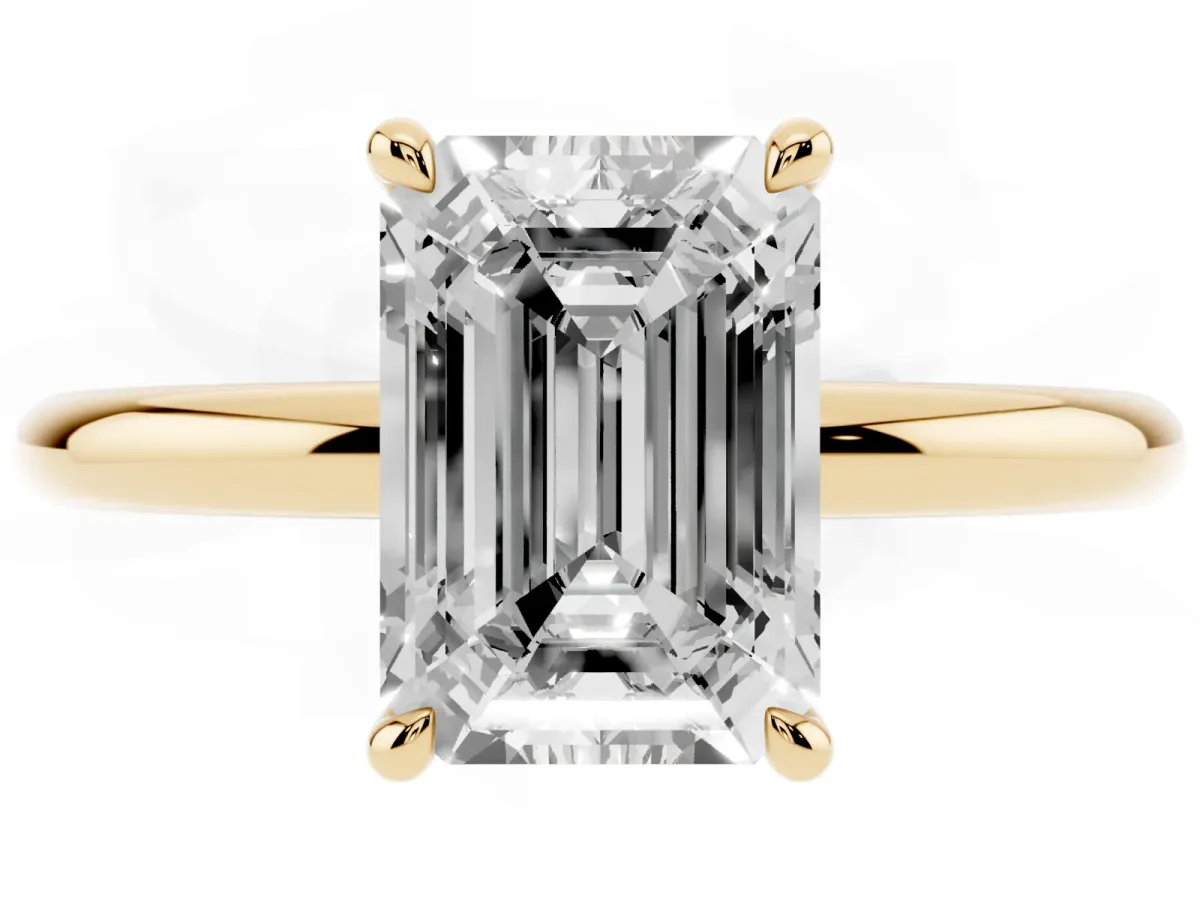 Emerald Cut Diamond Solitaire Ring with Thin Band and Four-Prong Setting Yellow gold
