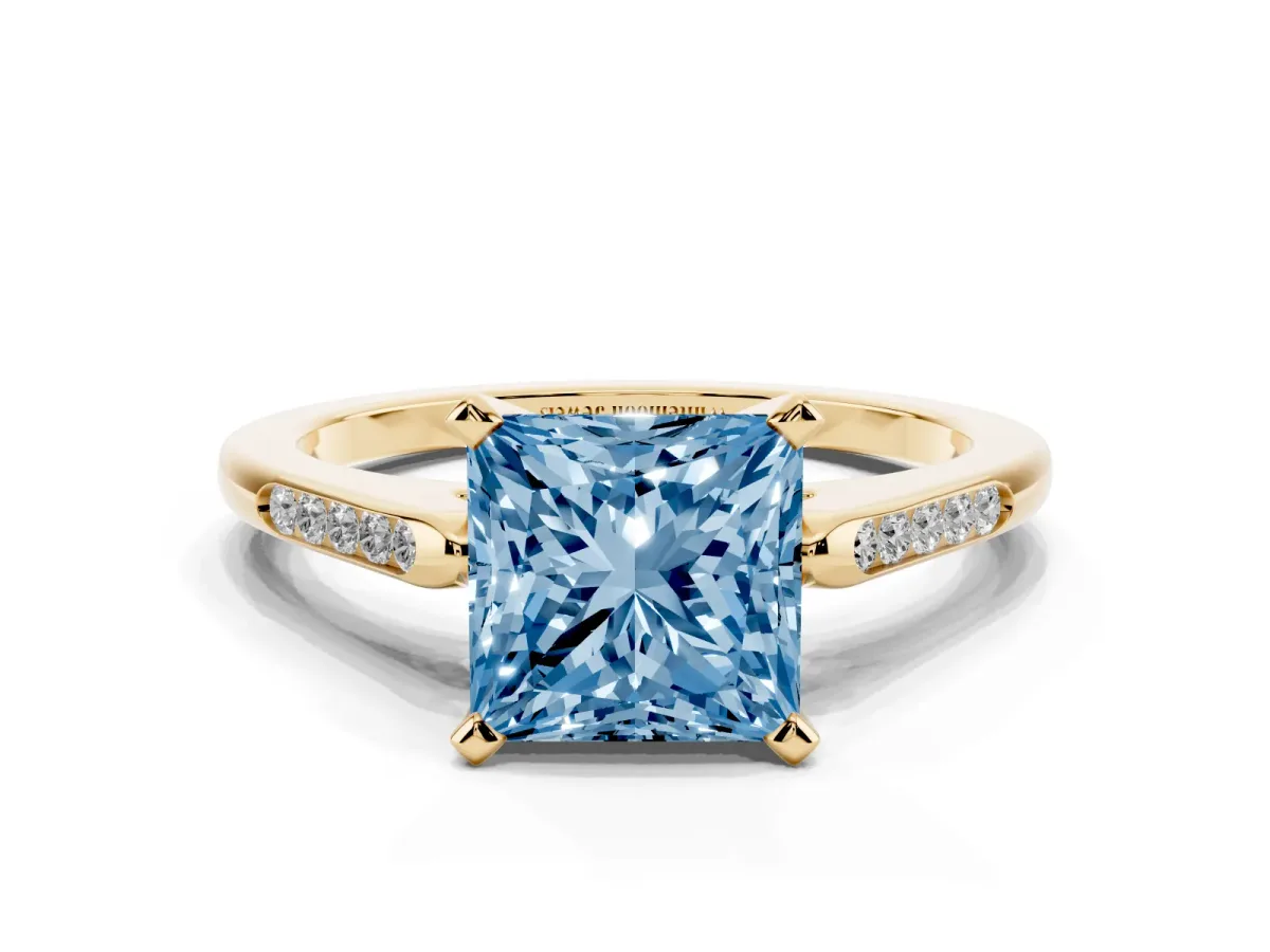 Fancy Blue Princess Cut Diamond Solitaire Ring with Channel Set Round Band and Prong Setting Yellow gold